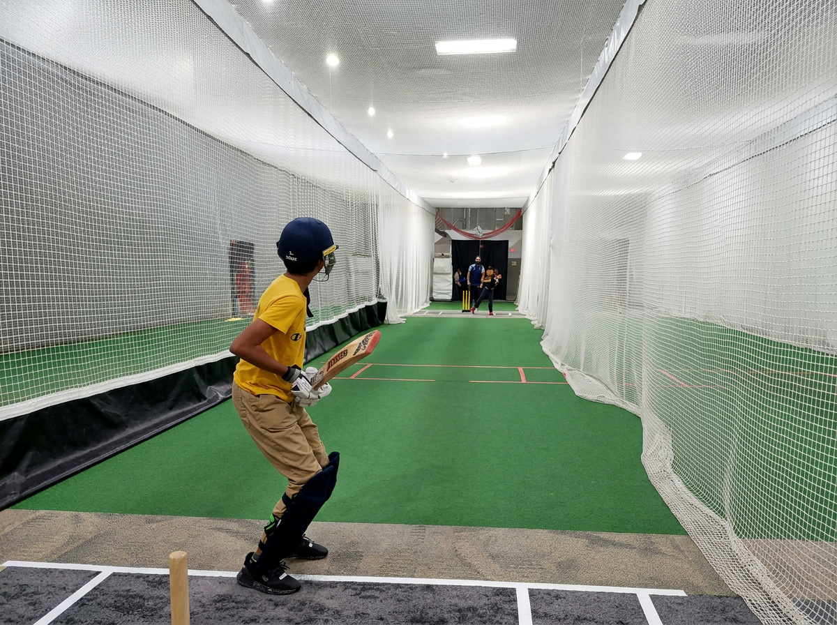Netted indoor training cages with turf lanes for cricket and baseball